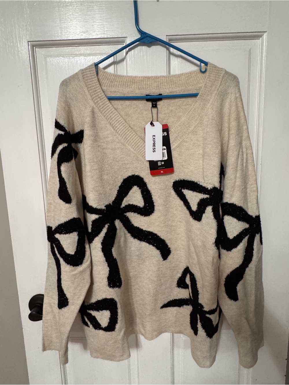 Express Beige V-Neck Sweater with Black Bow Motif